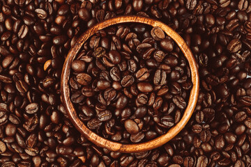 Wooden bowl filled with coffee beans. Coffee beans isolated.