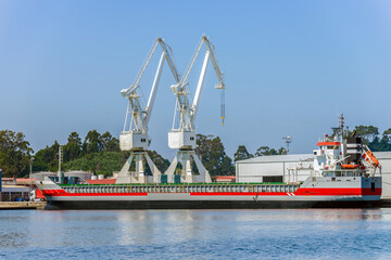 Fototapeta premium port cranes loading industrial cargo ship