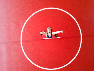 Aerial view of a boy celebrating his victory on the wrestling mat