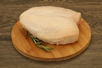 Raw whole chicken breast with skin