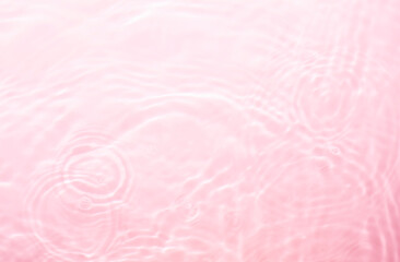 Pink splashing cosmetic moisturizer, micellar water, toner, or emulsion background
