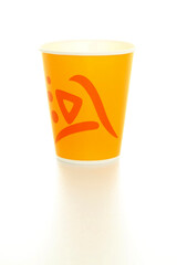 Yellow disposable glass on a white