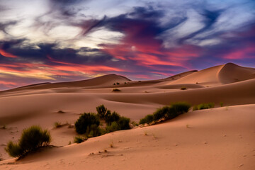 Naklejka na ściany i meble Dramatic and colorful sunset at The Sahara desert: Earth's Largest Hot Desert