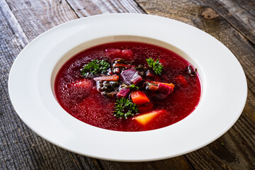 Borsch - beetroots soup on wooden table