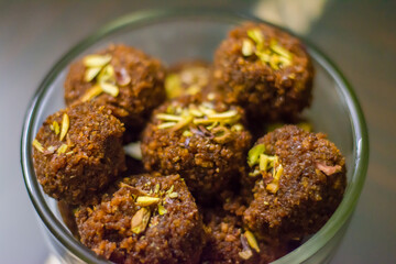 Fresh Homemade ladoo or laddu, made by bread crumbs with pistachio on it, with selective focus
