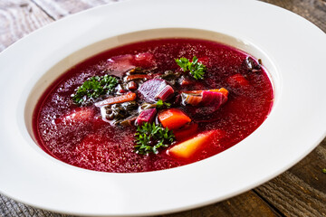 Borsch - beetroots soup on wooden table