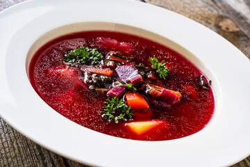 Borsch - beetroots soup on wooden table