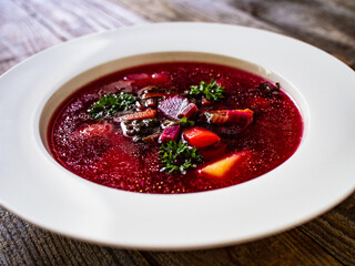 Borsch - beetroots soup on wooden table