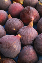 Vertical image of heap of magenta color fresh ripe figs	