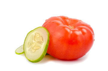Tomato and sliced cucumber on white background.