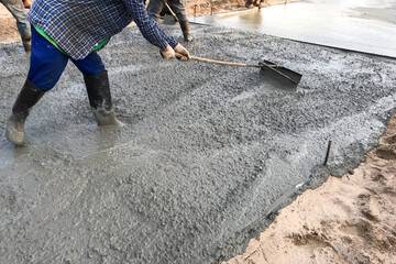 Workers pouring reinforced concrete floors on site