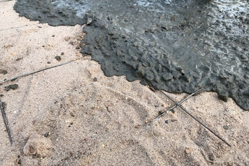 Workers pouring reinforced concrete floors on site