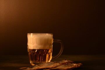 Beer mug and dried fish on dark background. Oktoberfest concept