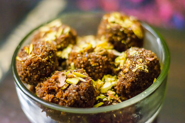 Fresh Homemade ladoo or laddu, made by bread crumbs with pistachio on it, with selective focus
