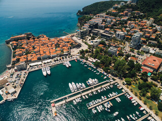 The old town of Budva and the pier for boats and yachts on the waterfront.