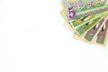 Saudi riyal banknotes on top right hand corner over white. Conceptual image.