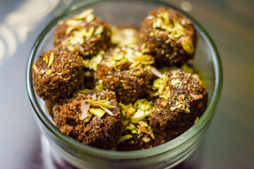 Fresh Homemade ladoo or laddu, made by bread crumbs with pistachio on it, with selective focus

