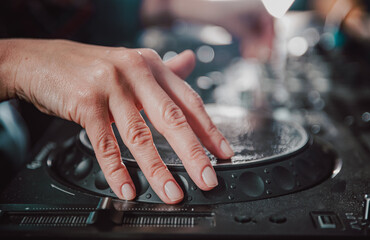 DJ Hands creating and regulating music on dj console mixer in concert nightclub stage