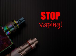 Conceptual of recent uncertainty of health safety of e-cigarette. Isolated close-up of atomizer attached to mouthpiece and battery over