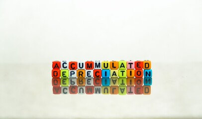 Conceptual of accumulated depreciation in financial statements. Colorful alphabet beads stacked forming the words over dark table. Selective Focus.