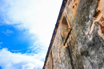 Low angle image old external brick wall of the ruin of st paul church in malacca malaysia. Blue sky in visibility. Focus selective on old wall