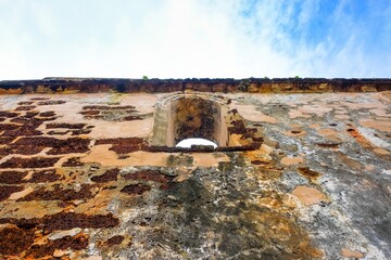 Low angle image old external brick wall of the ruin of st paul church in malacca malaysia. Blue sky in visibility. Focus selective on old wall