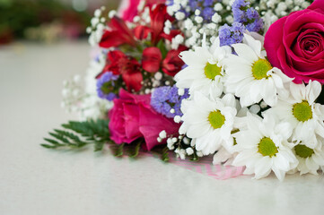 Colorful flower bouquet on the shelf. Flower business. Multi-colored bouquet. Selective focus. Macro photo.