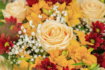 Colorful flower bouquet on the shelf. Flower business. Multi-colored bouquet. Selective focus. Macro photo.