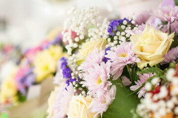Colorful flower bouquet on the shelf. Flower business. Multi-colored bouquet. Selective focus. Macro photo.