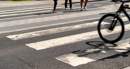Pedestrian and cyclists using a zebra crossing to cross the road