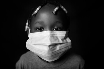 Little black girl wearing a face mask. Covid 19 concept