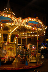 Colorful carousel at night in Paris. Authentic, vintage and historic merry-go-round in the city...