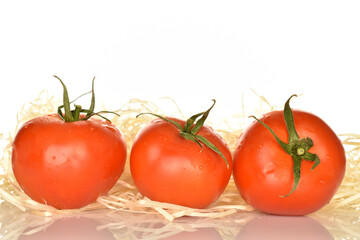 Fresh ripe, juicy, organic tomato, close-up, on a white background.