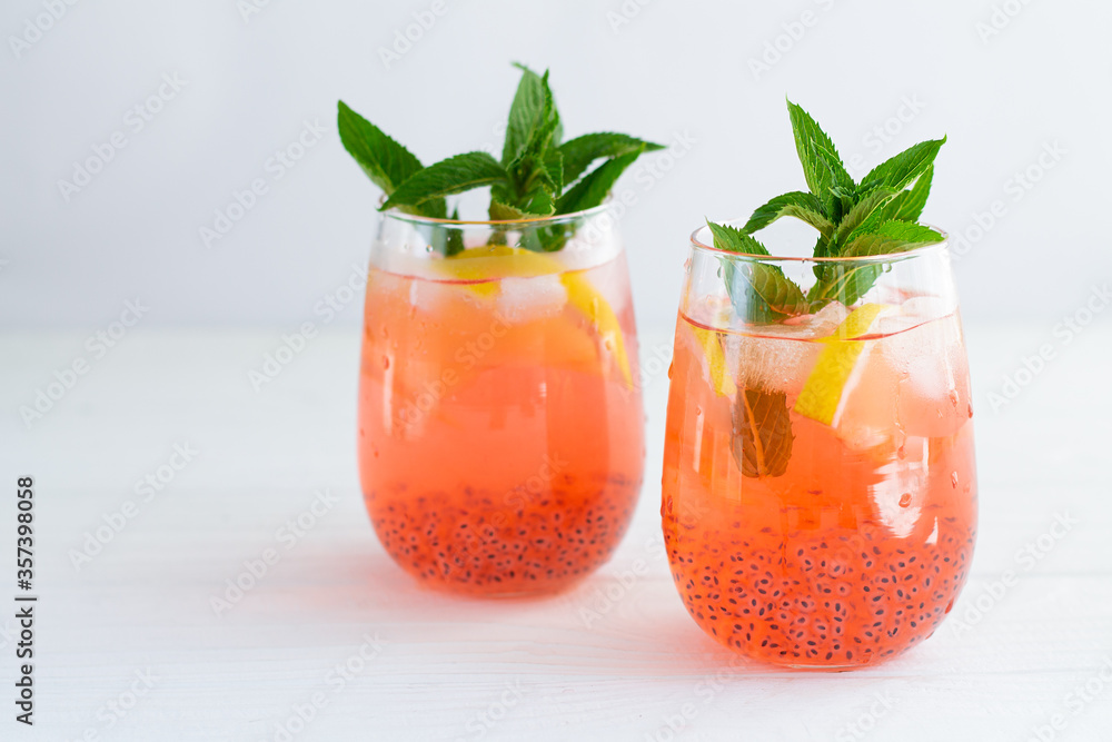 Wall mural trendy summer basil seeds iced drinks with citrus and mint