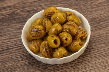 Green grilled olives in the bowl