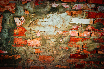 Red brick wall with messy spots of cement plaster on
