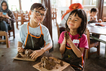 children are busy playing clay handicrafts in the pottery workshop gallery