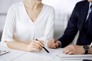 Unknown businessman and woman discussing contract in office. closeup.Business people or lawyers working together at meeting. Teamwork and partnership © rogerphoto