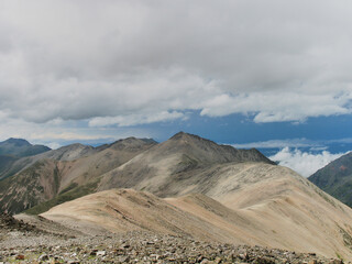 Amazing natural view of fast mountain river surrounded by green forest with sky as a background. Nature river landscape perspective.