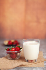 Strawberries arranged in pairs of bright white milk cups
