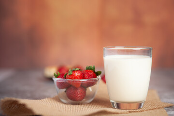 Strawberries arranged in pairs of bright white milk cups
