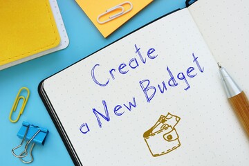 Motivation concept meaning Create a New Budget with sign on the piece of paper.