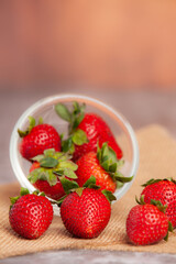 Strawberries are placed on a clear cup.
