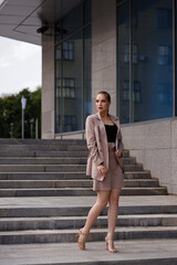 girl in a suit outside the office. lunch break. secretary, manager