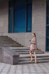 girl in an official suit goes to work and holds coffee in her hands. coffee break