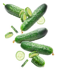 Falling fresh green cucumbers on white background