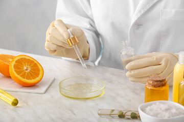 Beautician preparing natural cosmetic in laboratory, closeup