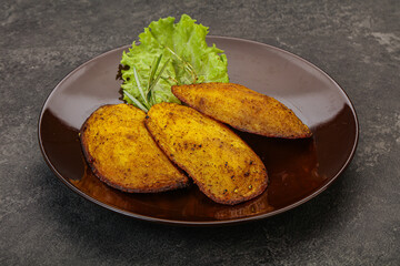 Baked potato with herbs and spices