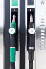 Fuel pumps. Diesel and gasoline pistol hanging on petrol pump machine