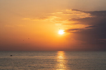 Golden sunset on the seashore. Evening Seascape, calm sea.